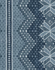 Blue wallpaper detail with scattered dot motifs and oversized snowflake medallion