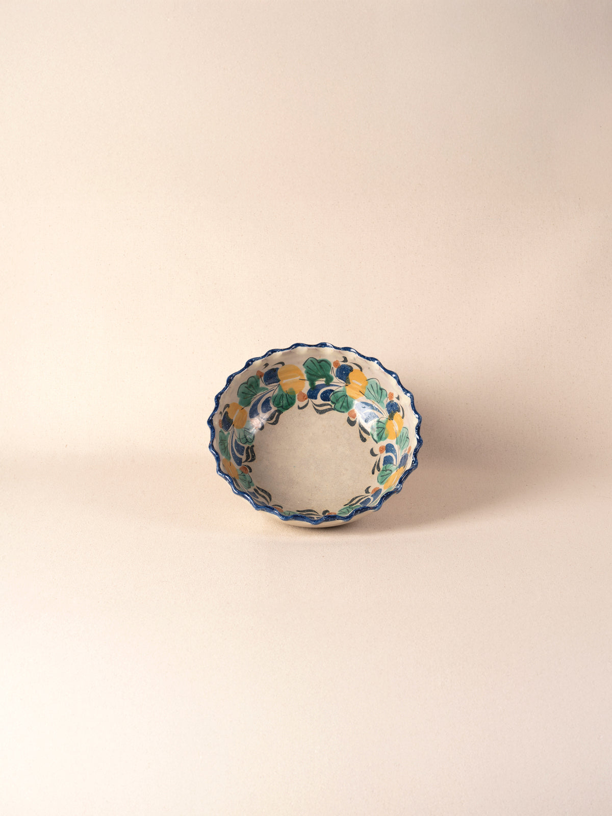 Vintage Mexican pottery bowl with a multicolor painted floral rim