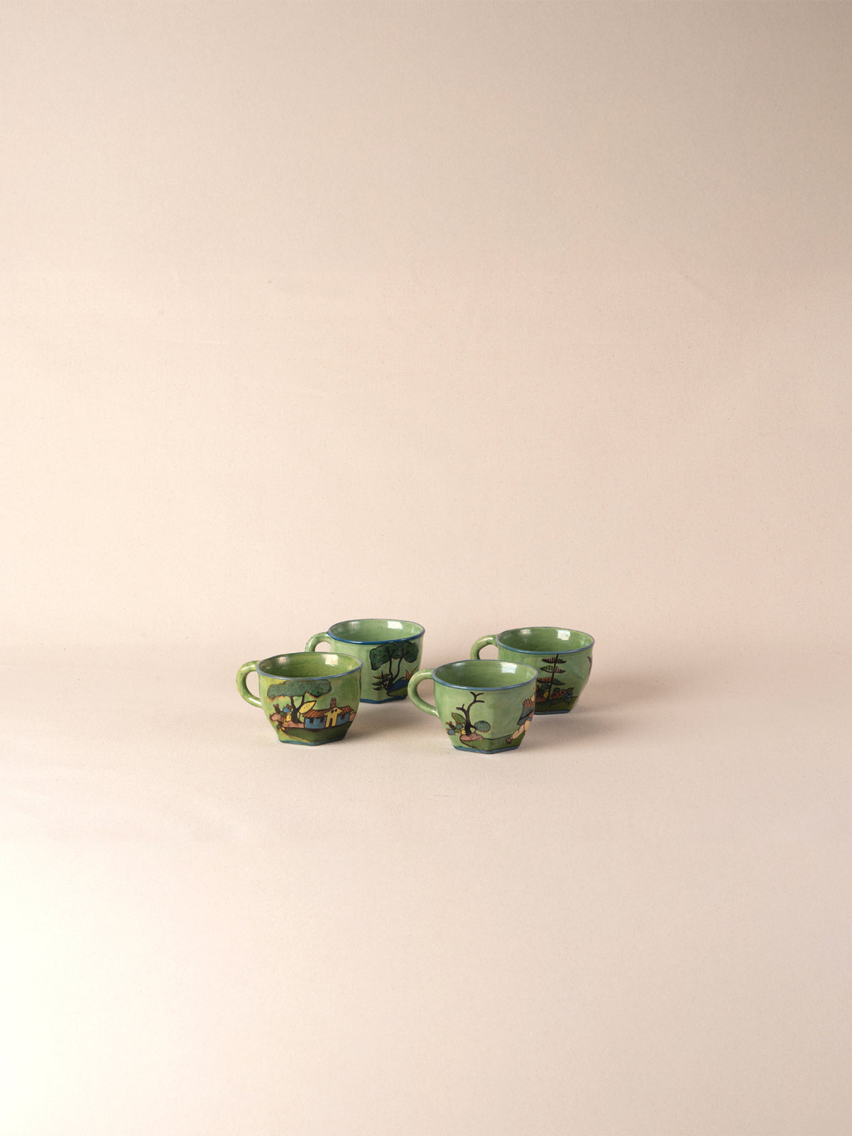 Set of four hand-painted vintage Mexican ceramic teacups in green