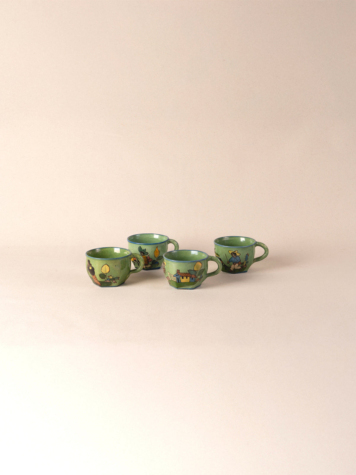 Set of four hand-painted vintage Mexican ceramic teacups in green