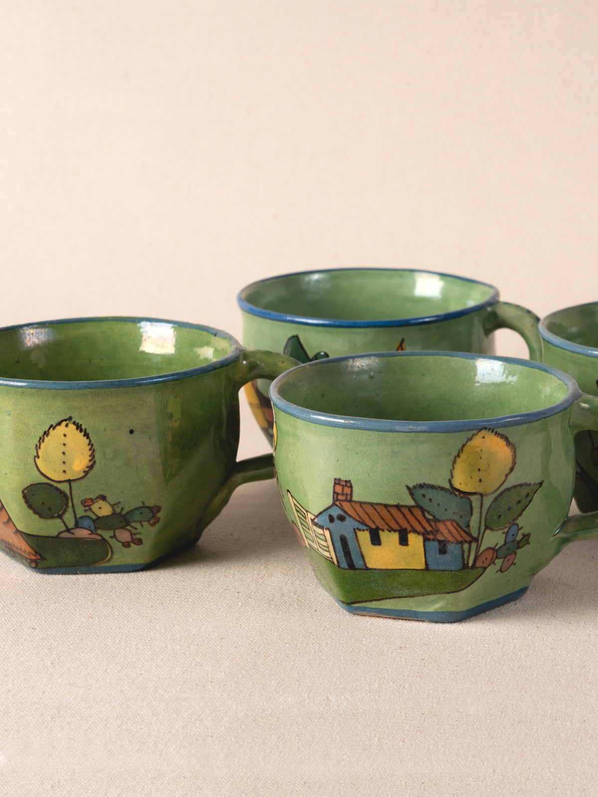 Set of four hand-painted vintage Mexican ceramic teacups in green