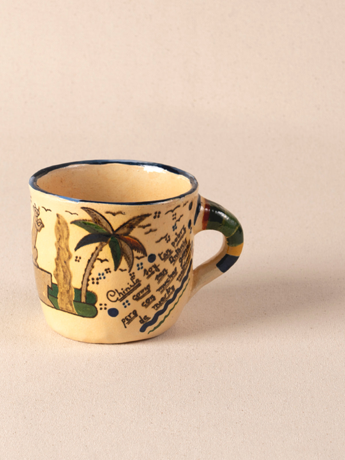 Hand-painted vintage Mexican ceramic teacup with a multicolor striped handle