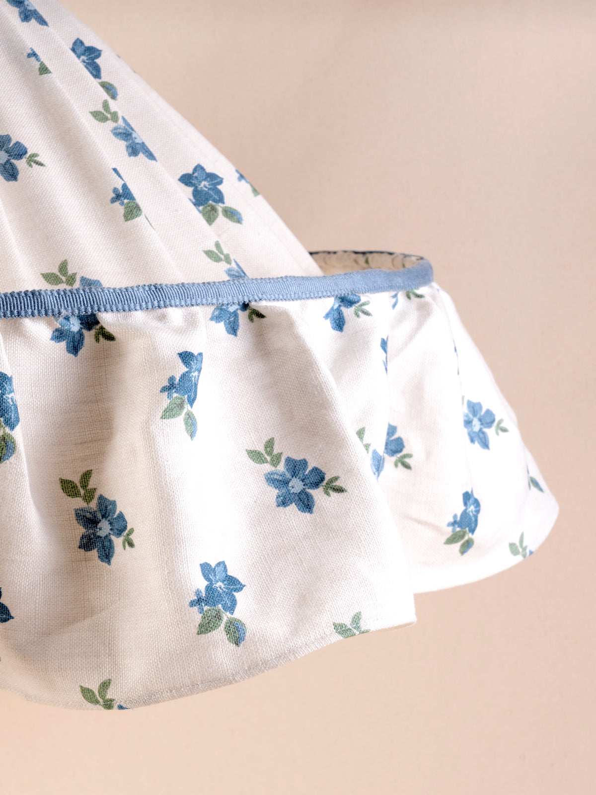 Large ruffled pendant light with a pleated blue and green floral linen shade and blue trim