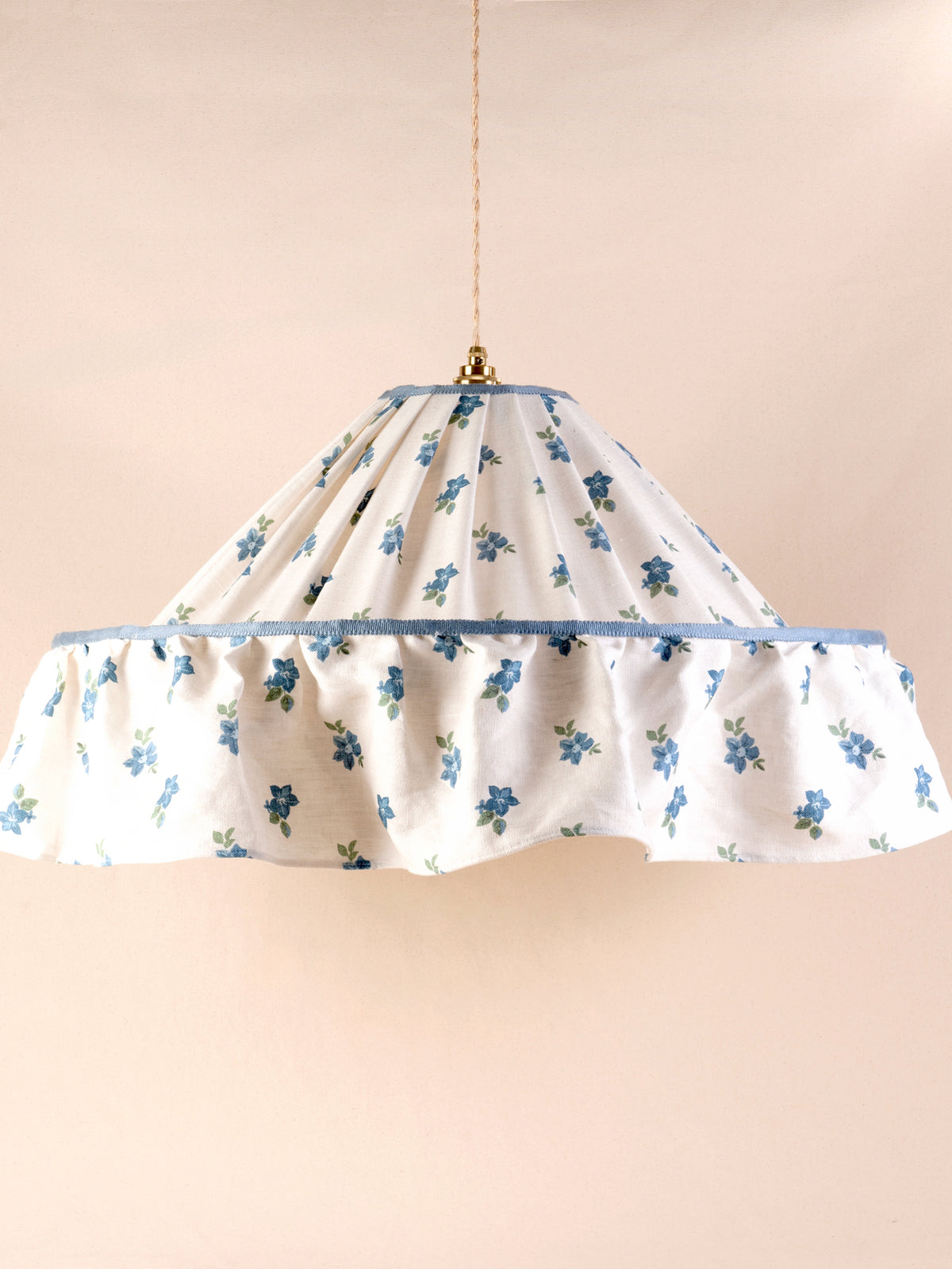Large ruffled pendant light with a pleated blue and green floral linen shade and blue trim