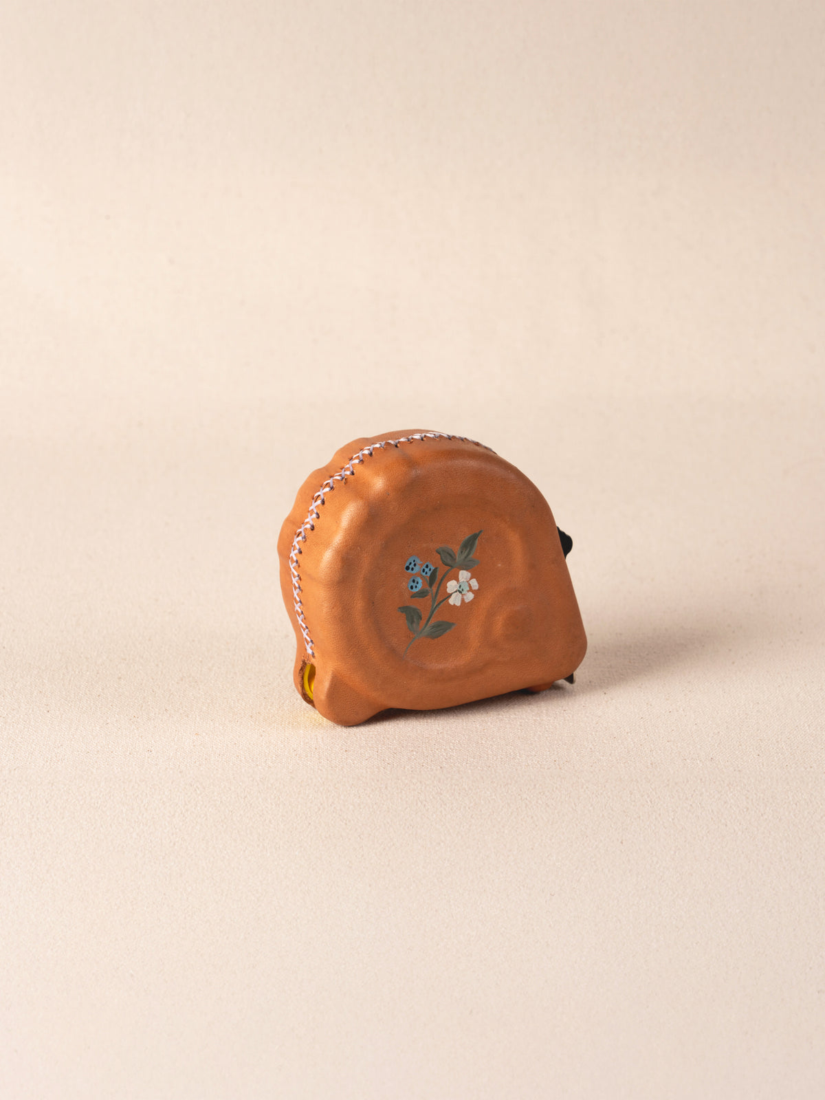Hand-painted leather-covered 25-foot tape measure