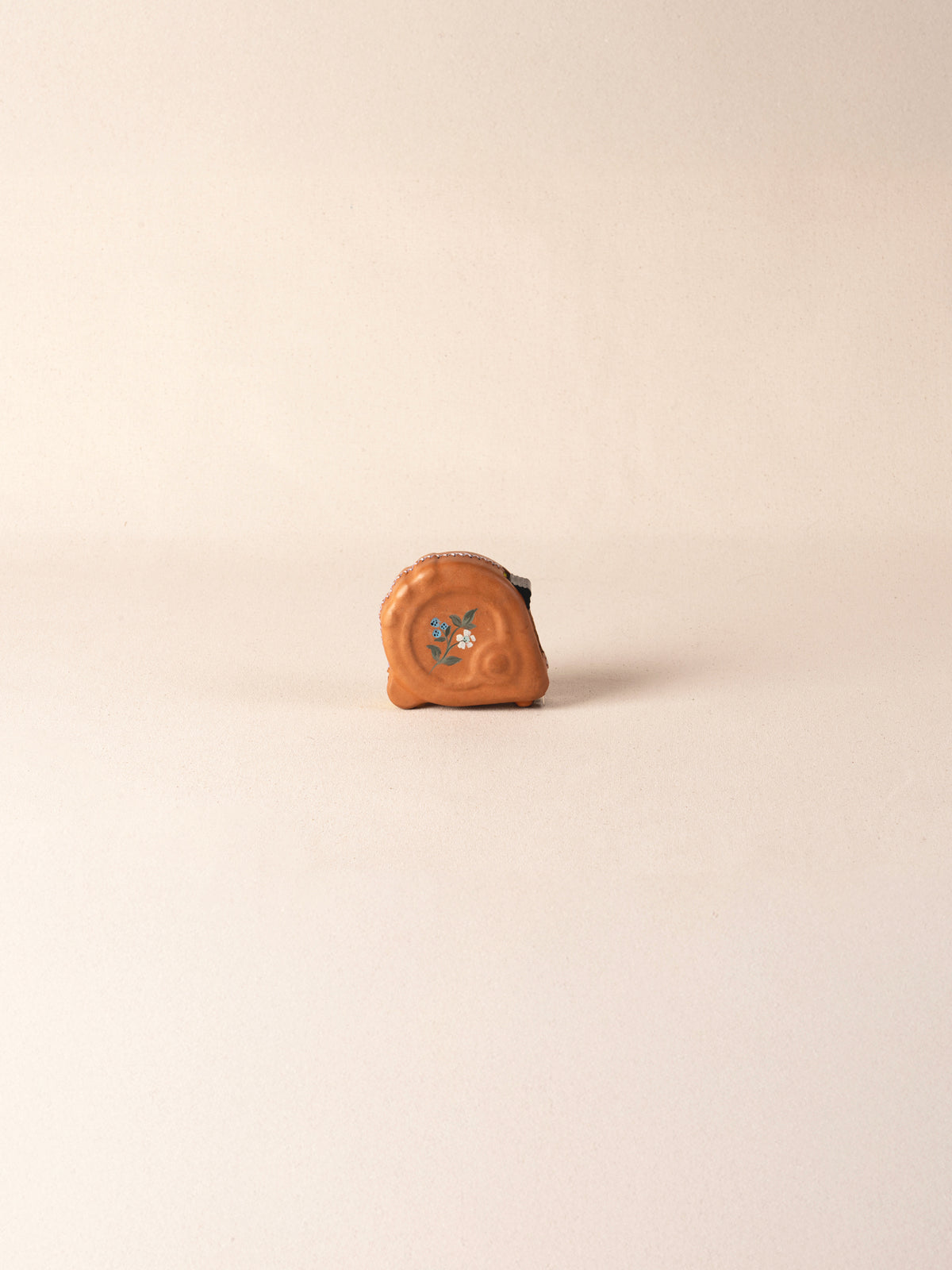 Hand-painted leather-covered 25-foot tape measure