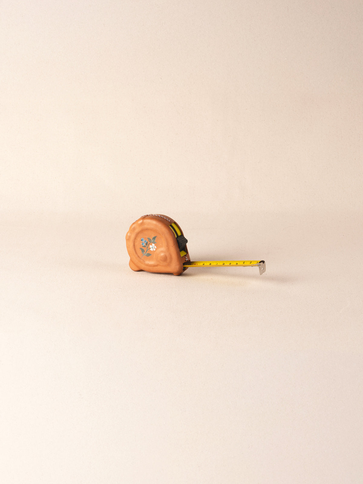 Hand-painted leather-covered 25-foot tape measure
