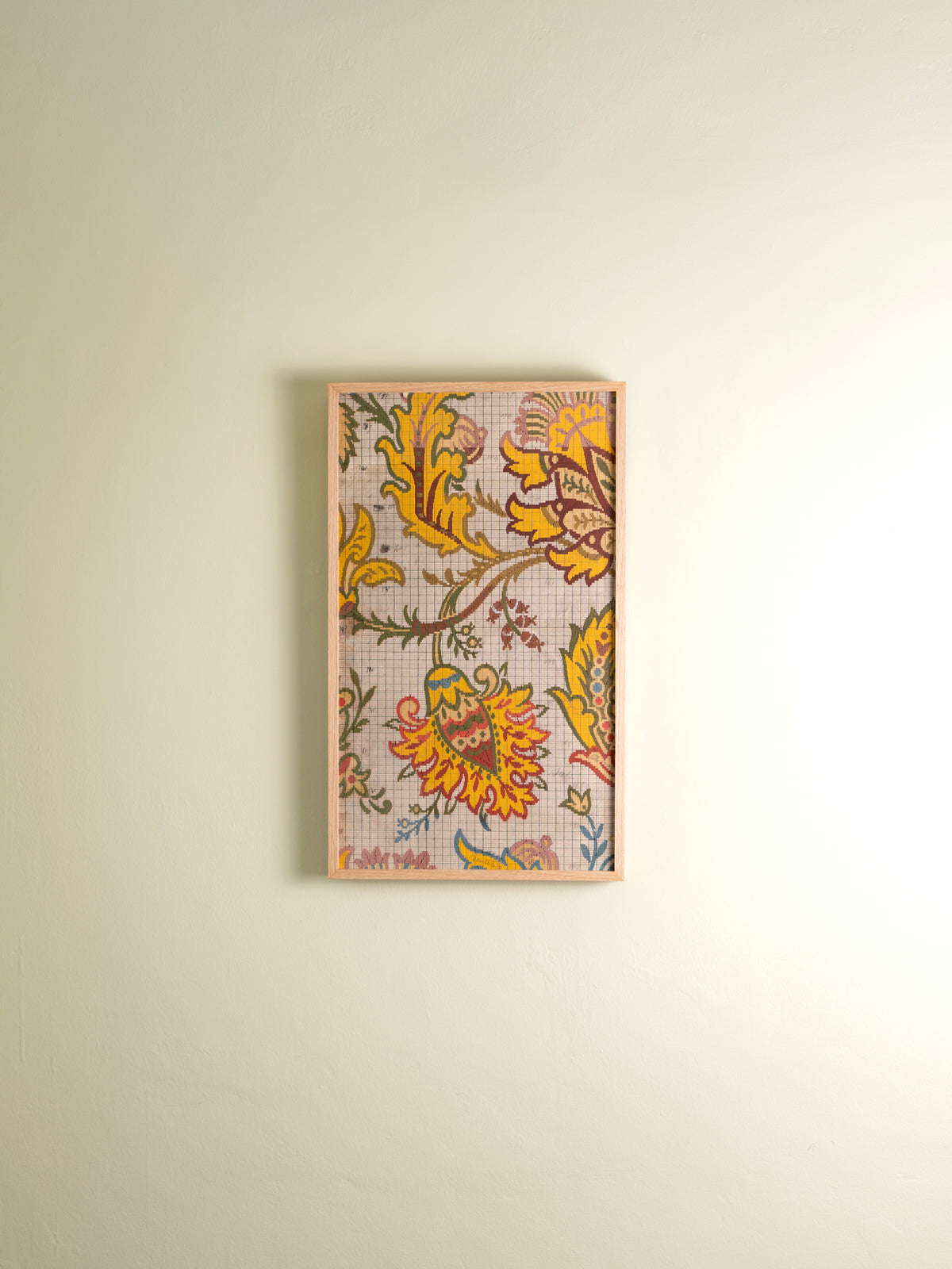 Two framed antique wallpaper panels in a multicolor paisley design