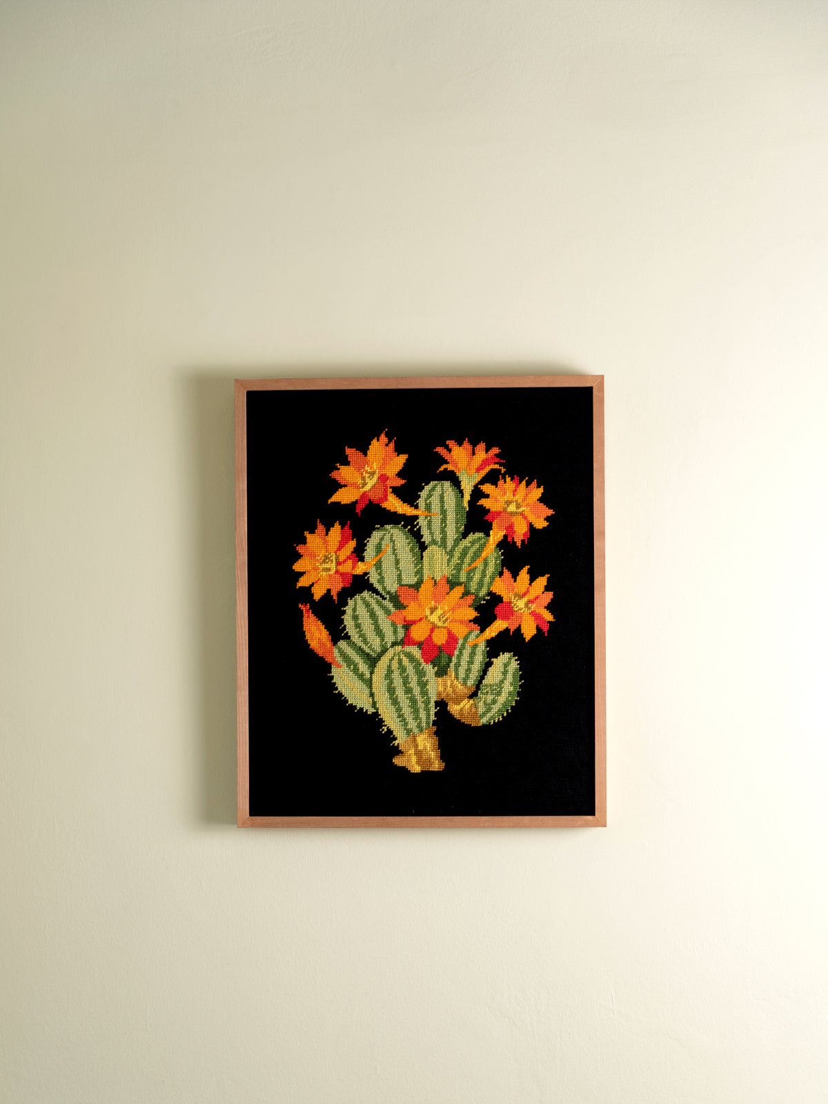 Framed vintage needlepoint of a flowering cactus