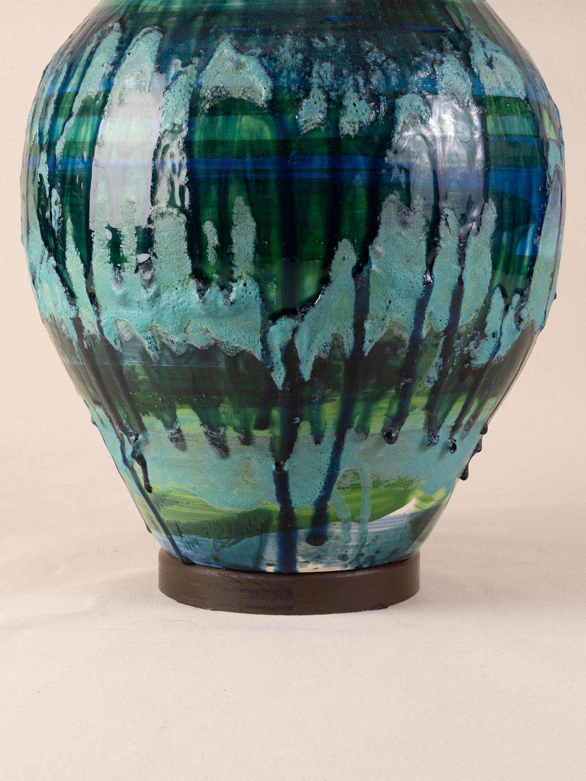 Mid-century ceramic table lamp with blue-green drip glaze on a wood plinth with burlap drum shade