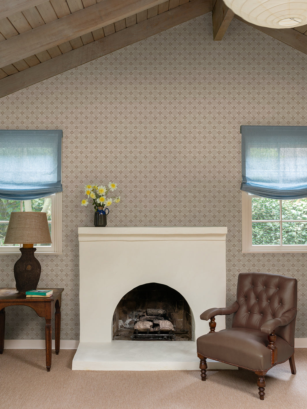 Brown-and-cream floral lattice wallpaper on walls beside fireplace and seating