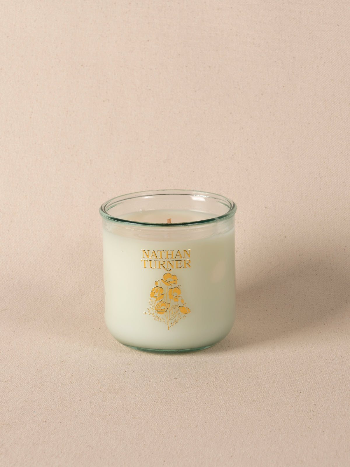 Orange blossom scented candle in a clear glass jar