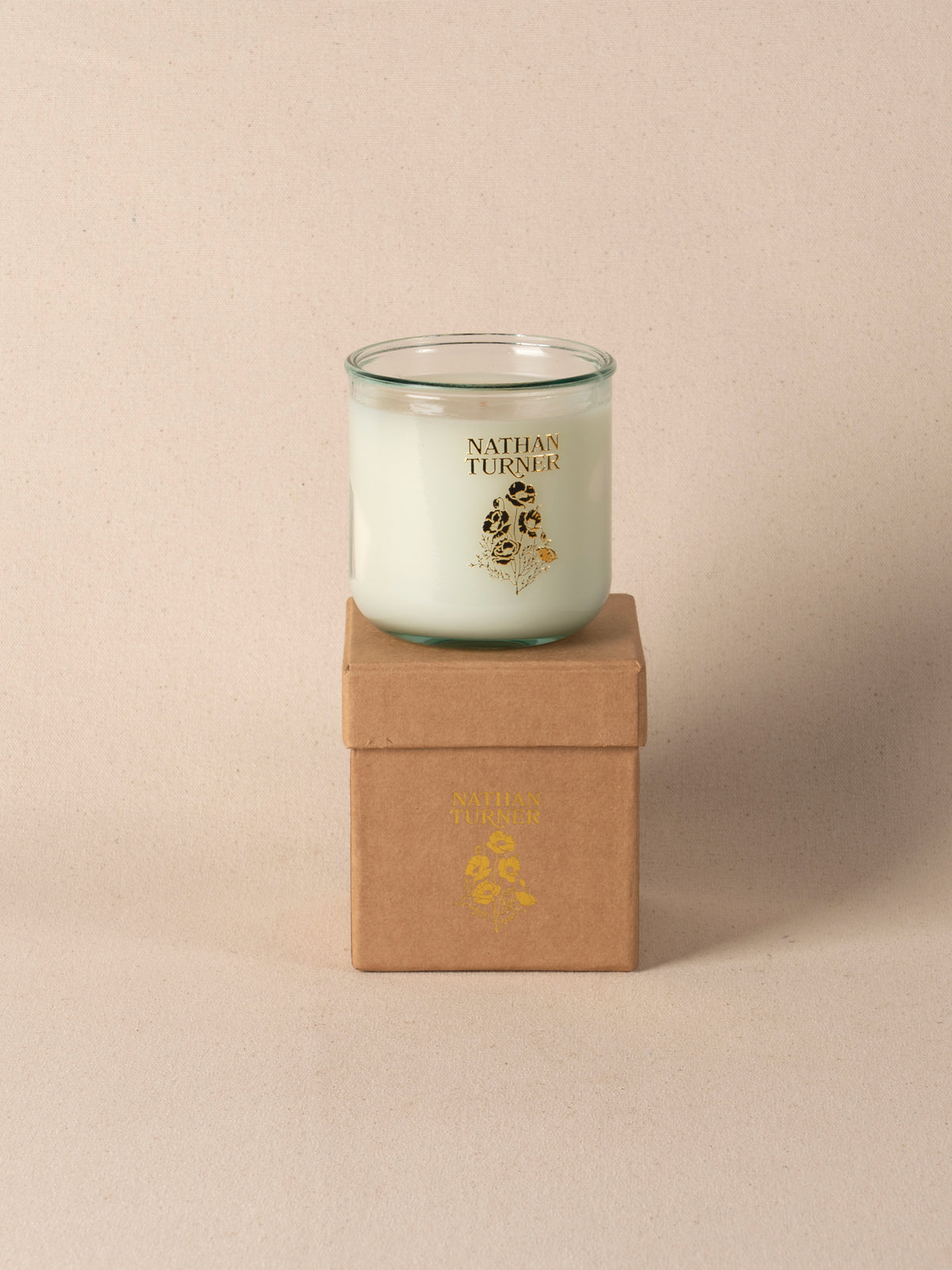 Orange blossom scented candle in a clear glass jar