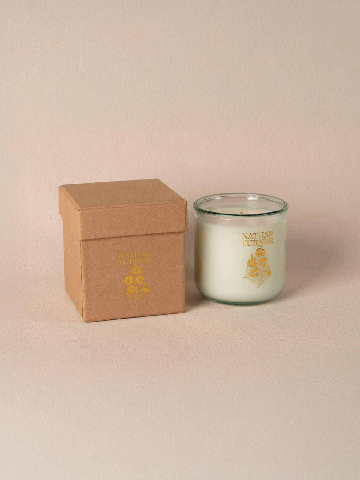 Orange blossom scented candle in a clear glass jar