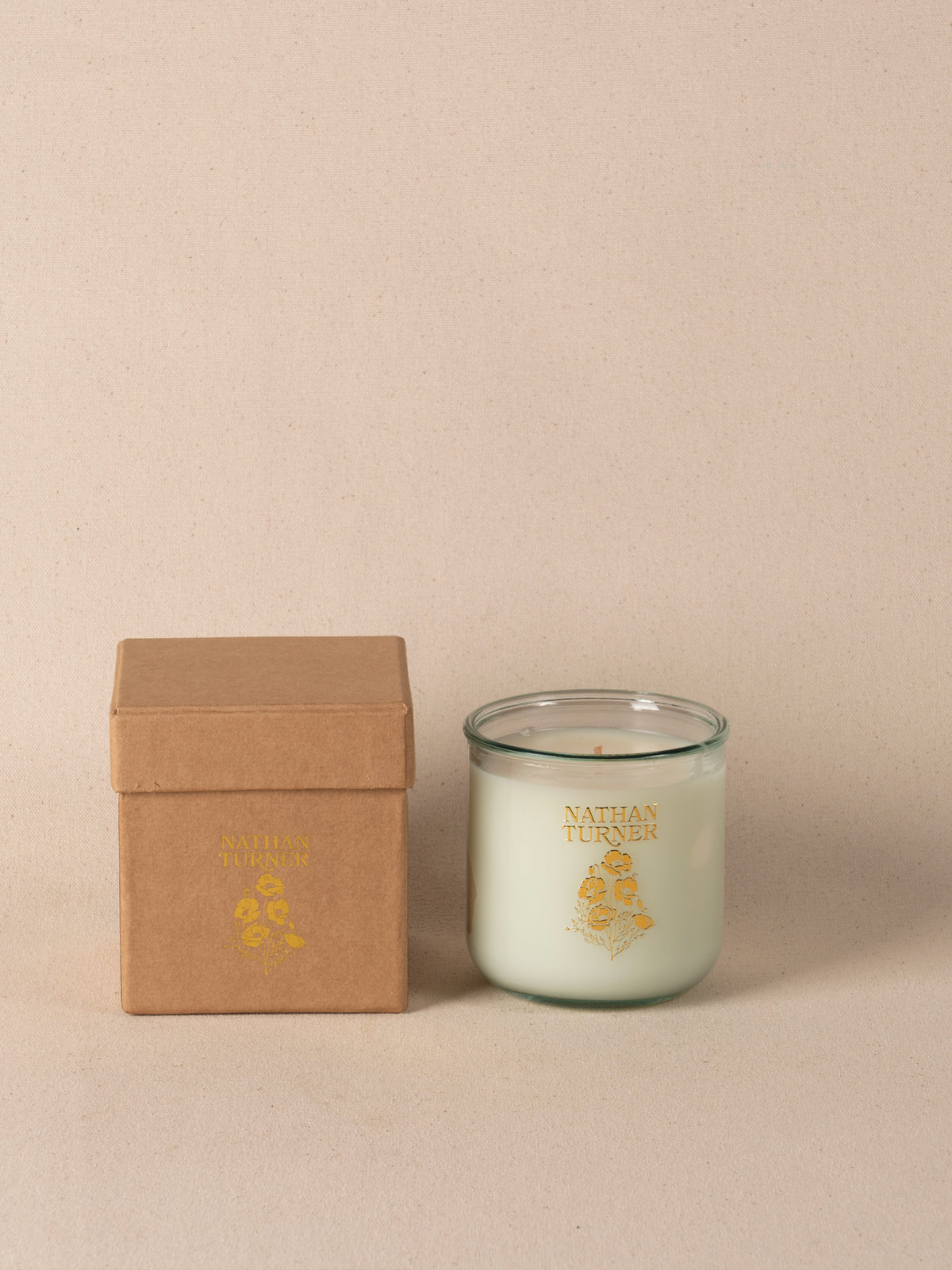 Orange blossom scented candle in a clear glass jar