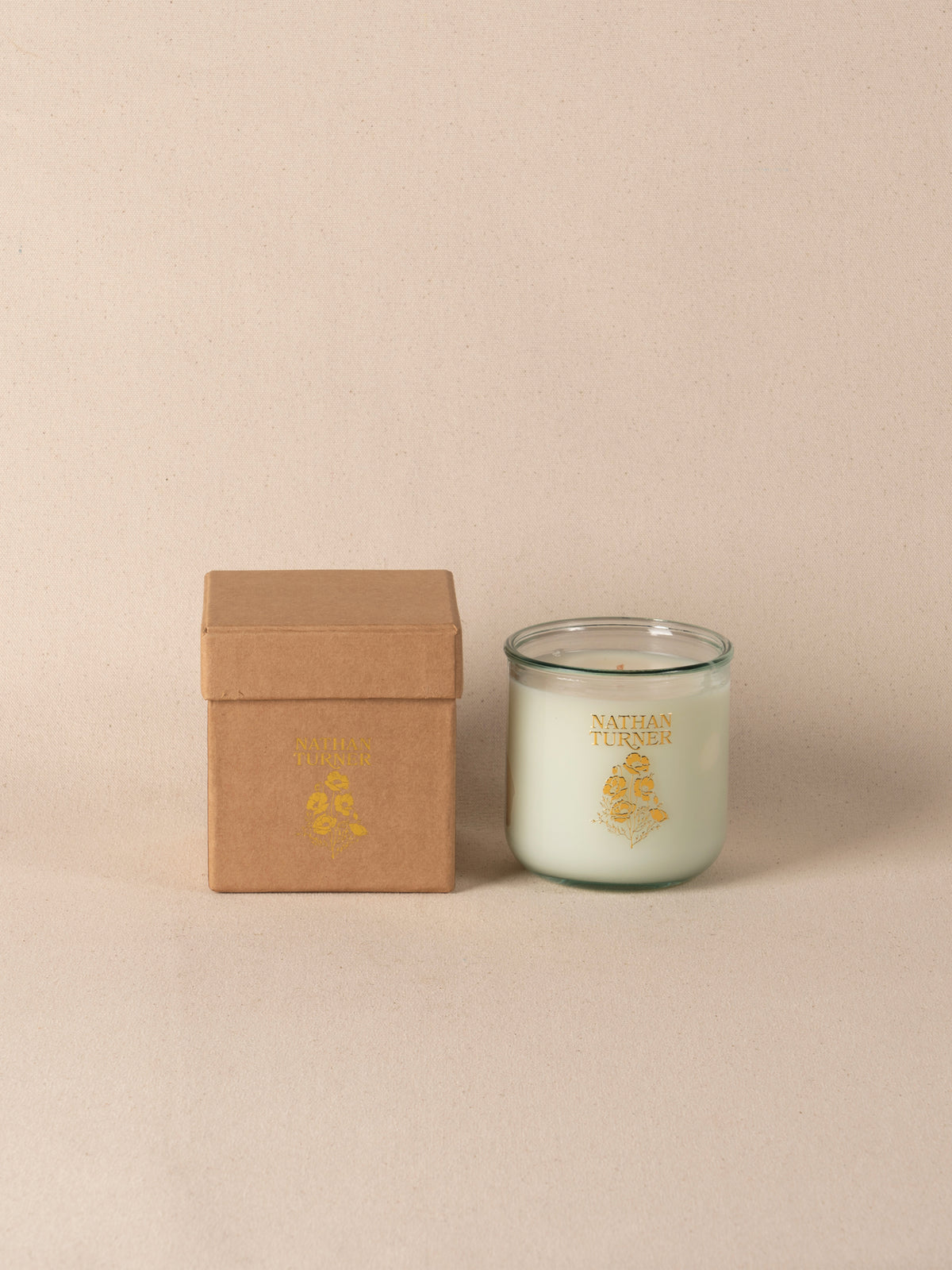 Orange blossom scented candle in a clear glass jar
