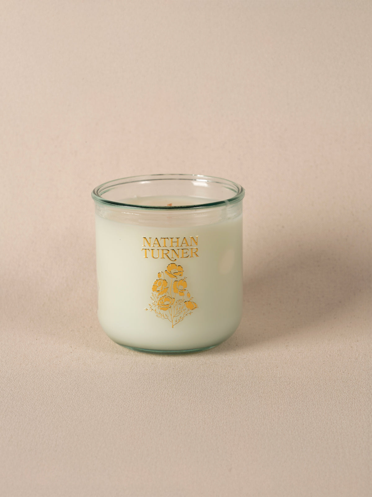 Orange blossom scented candle in a clear glass jar