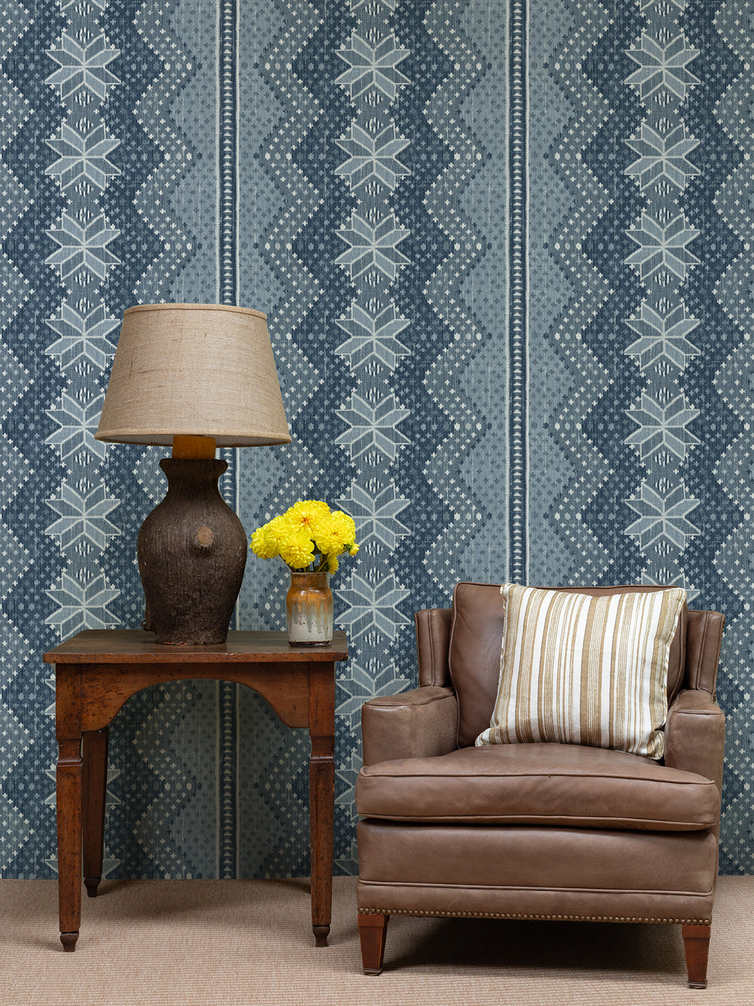 Blue wallpaper with vertical panels of zigzag chevrons and repeating snowflake icons