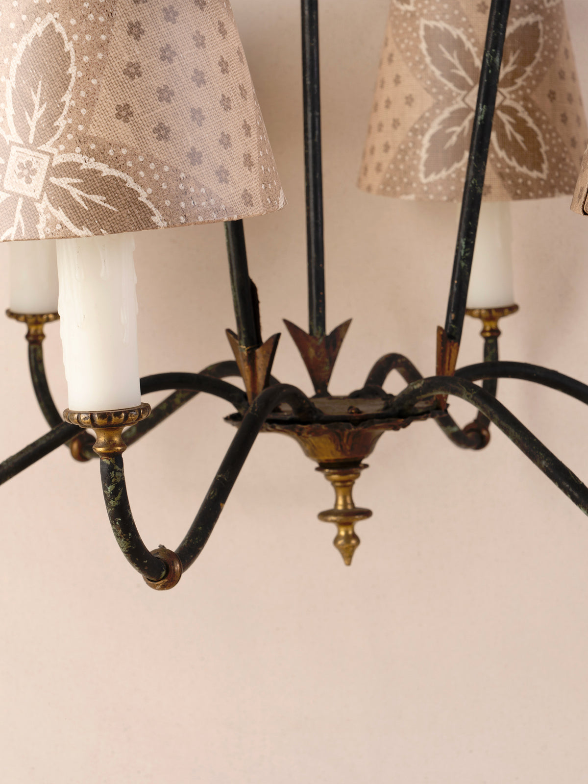 Antique three-arm dark iron chandelier with small linen shades