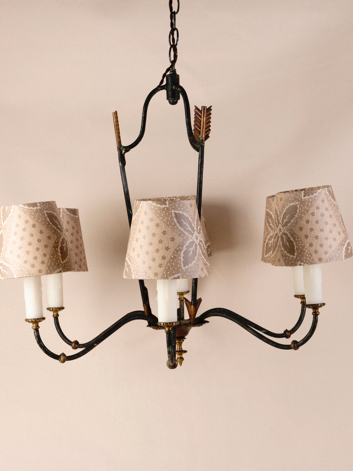 Antique three-arm dark iron chandelier with small linen shades