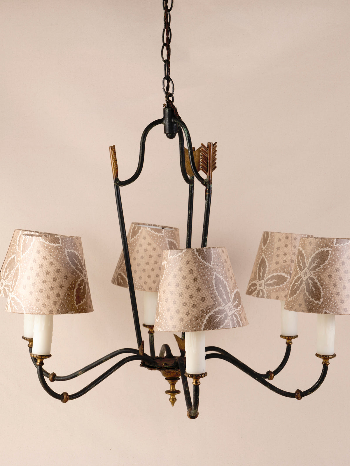 Antique three-arm dark iron chandelier with small linen shades