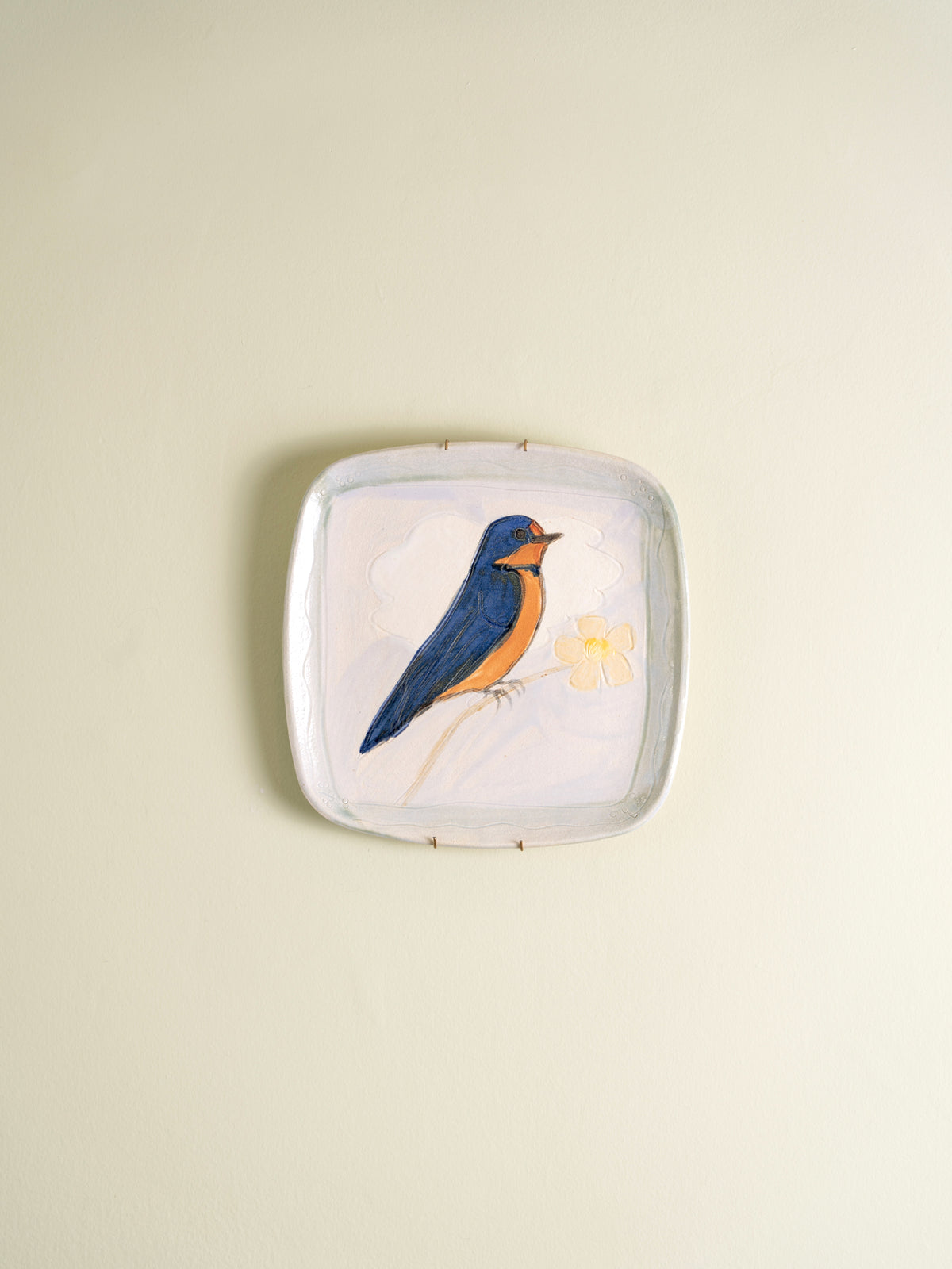 Set of four mid-century ceramic plates painted with birds and a cat