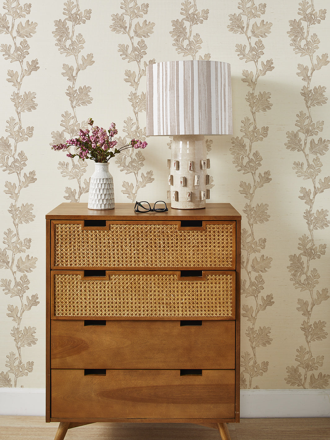 Neutral grasscloth wallpaper with beige oak leaf and branch pattern